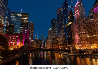 Chicago Illinois City Skyline At Night Overlooking The River And Bridge With Buildings Lit Up In The Background Long Exposure With Dark Sky