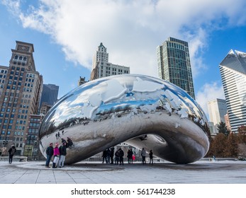 Chicago, Illinois - Dec 15, 2016 : Tourists visit The cloud gate or " The bean" that have snow on top in winter season at Millennium Park in Chicago, 