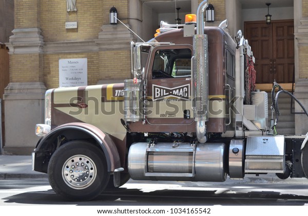 CHICAGO, ILLINOIS - JUNE 1, 2017: Diesel truck\
cab waits to deliver material at near north side high rise\
construction site on West Illinois Street.\
