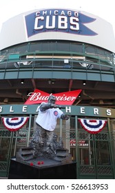 Chicago, Illinois - October 23, 2016: A Statue Of Sportscaster Harry Caray Outside Wrigley Field Wearing A Cubs Jersey Under The Neon Chicago Cubs Sign.