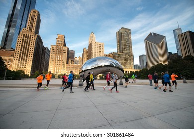 CHICAGO, ILLINOIS - OCTOBER 9: Cloud Gate (The Bean) On October 6, 2012 In Chicago, Illinois. Chicago Cloud Gate Sculpture And Downtown Chicago Skyline Buildings In Millenium Park At Early Morning