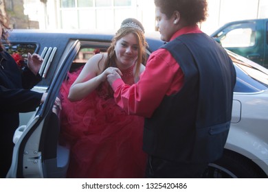 Chicago Illinois/ United States December 16th 2016:  Young Girl Is Having Her Quinceanera Celebration As A Young Man Is Helping Her Exit The Car