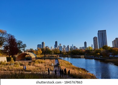 CHICAGO, ILLINOIS / UNITED STATES - OCTOBER 31, 2020: People Stroll Though Lincoln Park And Take In The Fall Foliage And The Chicago Skyline.