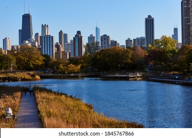 CHICAGO, ILLINOIS / UNITED STATES - OCTOBER 31, 2020: People Stroll Though Lincoln Park And Take In The Fall Foliage And The Chicago Skyline.