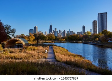 CHICAGO, ILLINOIS / UNITED STATES - OCTOBER 31, 2020: People Stroll Though Lincoln Park And Take In The Fall Foliage And The Chicago Skyline.