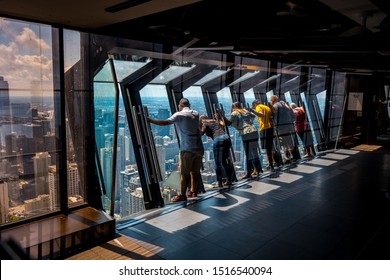 Chicago, Illinois, USA - Aug 15, 2019: Tilting glass at John Hancock Center observation area