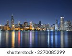 Chicago, Illinois, USA downtown skyline from Lake Michigan at dusk.