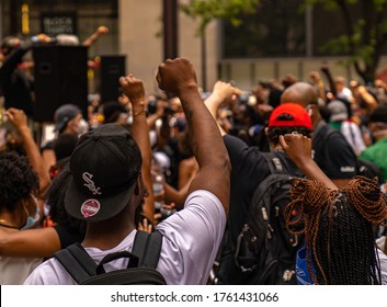 Chicago, Illinois / USA - June 19 2020. Black Man Hold Fist in the Air During a Peaceful Protest Juneteenth Rally in Daley Plaza in the Loop of Downtown Chicago over George Floyd Death with White Sox