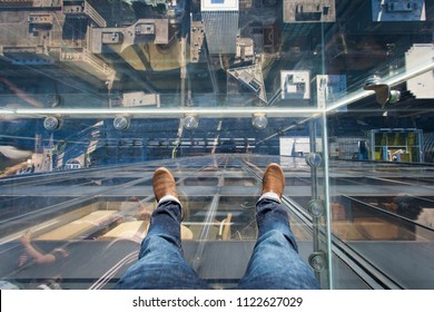 Chicago, Illinois, USA - June 2016: Looking Down From The Glass Box Ledge Of The Willis Tower Skydeck, With Downtown Chicago Visible Beneath The Glass Floor