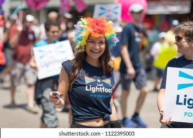 Chicago, Illinois, USA - June 24, 2018 Young Woman Wearing A Wig With The Colors Of The Rainbow And A Shirt That Promotes Lori Lightfoot For Chicago During The LGBTQ Pride Parade In Chicago