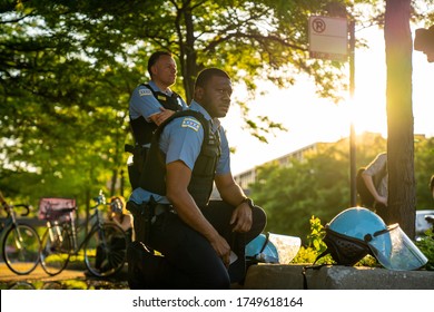 Chicago, Illinois / USA - June 4 2020: Male Police Officer Taking a Knee in Solidarity at a Peaceful Protest and Rally in Downtown Chicago Neighborhood over George Floyd Death. 