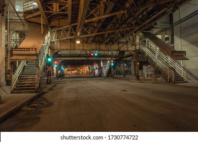 Chicago, Illinois. USA - May 1, 2020: Empty Street In Downtown Chicago At Night With Train Overpass And Stairs