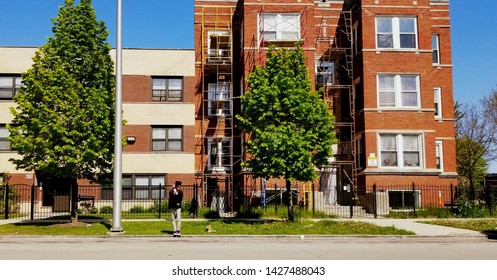 Chicago, Illinois / USA - May 17 2019: A colorful shot of a kid crossing the street in Bronzeville, a neighborhood on the Southside of Chicago.