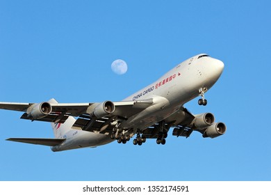 Chicago, Illinois, USA - May 26, 2018: China Cargo Boeing 747-8F Cargo Plane Approaching The Runway For A Landing At The Chicago O'Hare International Airport With A Full Moon Behind It. 