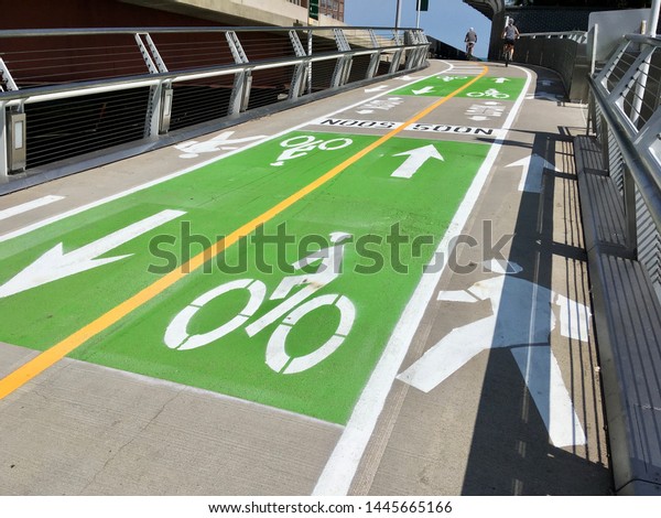 CHICAGO, ILLINOIS/JULY 8, 2019:\
Divided bicycle and pedestrian trail is marked for wayfinding\
travel over newly opened flyover bridge project at Navy Pier\
