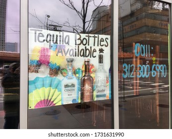 CHICAGO, ILLINOIS/MAY 14, 2020: Mexican Theme Restaurant  Has Tequila Bottles While Offering Pandemic Curb Delivery At West Fulton District