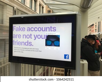 Chicago, Illinois/USA- April 4, 2018. Exterior Train Stop In Chicago Featuring A Facebook Ad Warning Against Fake Accounts. People Nearby Wait For The Train.