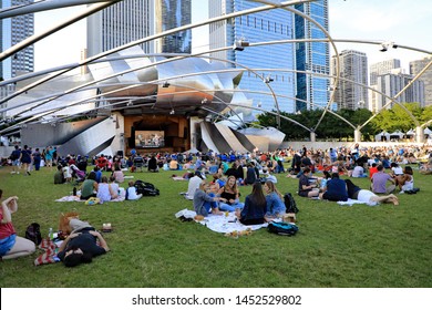 CHICAGO, ILUSA - JULY 8, 2019: Another Free Outdoor Concert At The Pritzker Amphitheater In Millennium Park In Downtown Chicago.  Friends And Family Enjoy The Music And Picnic On The Lawn.