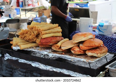 CHICAGO - JULY 2021: Flautas And Buns Stacked And Ready For Filling At A Latino Street Fair Food Festival In July 2021 In Chicago. The Fiesta Celebrates Latino Food And Heritage.