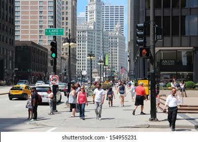 CHICAGO - JUNE 27: People Walk Downtown On June 27, 2013 In Chicago. Chicago Is The 3rd Most Populous US City With 2.7 Million Residents (8.7 Million In Its Urban Area).