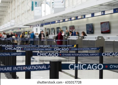 Chicago O'Hare international airport, check in counter, focus at belt line blur people background.