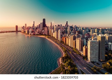 Chicago skyline aerial view with  sunrise above downtown buildings and Lake Michigan. Light effect applied.