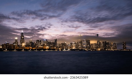 Chicago skyline with dramatic clouds at sunset.