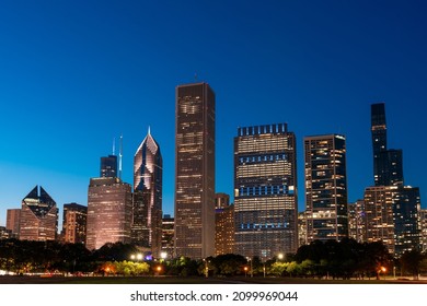 Chicago Skyline Panorama From Park At Night Time. Chicago, Illinois, USA. Skyscrapers Of Financial District, A Vibrant Business Neighborhood.