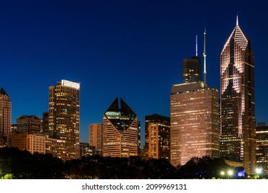 Chicago Skyline Panorama From Park At Night Time. Chicago, Illinois, USA. Skyscrapers Of Financial District, A Vibrant Business Neighborhood.