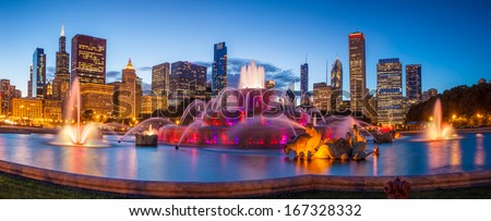 Chicago skyline panorama with skyscrapers and Buckingham fountain at twilight.