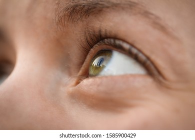 The Chicago skyline reflected in a woman's open eye - Powered by Shutterstock