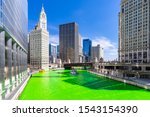 Chicago Skylines building along green dyeing river of Chicago River on St. Patrick day festival in Chicago Downtown IL USA