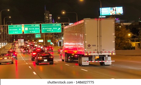 CHICAGO, UNITED STATES - 20 OCTOBER 2016: FPV Heavy Traffic On Multiple Lane Highway Towards Iconic Chicago City Skyline. Cars Caught In Jam During The Rush Hour On Busy Interstate Freeway At Night