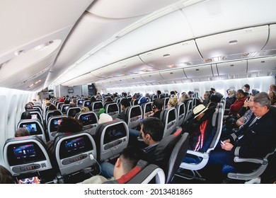 Chicago, USA - Circa 2015: Inside a local flight in American Airlines plane with diverse races passengers