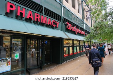 CHICAGO, USA - JUNE 26, 2013: People walk by Walgreens Pharmacy in Chicago. Walgreens is the largest drug retail chain in the United States with 8,300 stores in 50 states.