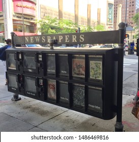 Chicago, USA; June 27, 2019: An Empty Newspaper And Magazine Stand Rendered Obsolete By The Internet, Along A Sidewalk Near Michigan Avenue.