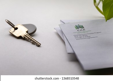 Chicago, USA-April 10, 2019: A Letter Or Mail From Chicago Housing Authority Is Displayed With A Door Key And Key Fob. Public Housing Assistance Program, CHA, Housing And Urban Development.