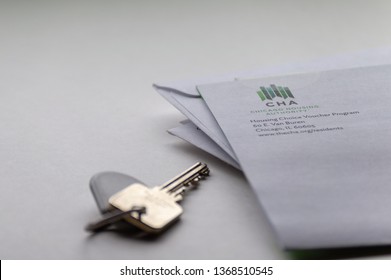 Chicago, USA-April 10, 2019: A Mail Piece Or Letter From Chicago Housing Authority CHA Is Displayed With A Door Key And Key Fob. Public Housing Assistance, Housing And Urban Development.