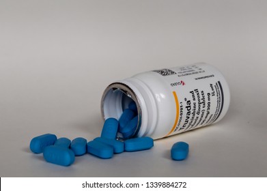 Chicago, USA-March 13, 2019: An Open Bottle Of Truvada Or PrEP Prescription Medication Is Used To Prevent And Treat HIV Infection With Blue Pills Displayed. It Is Taken Once A Day. Modern Medicine.