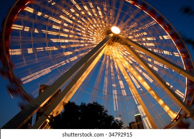 Chicago's Navy Pier Amusement Park At Night With Lighted Ferris Wheel