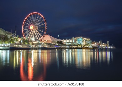 Chicago's Navy Pier With Lighted Ferris Wheel At Night