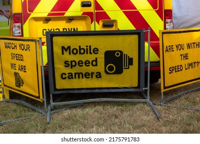 Chichester, Sussex, UK - 24 June 2022: An Exhibition Of Signs And Technology From The Sussex Safety Camera Team, Yellow High Visibility Vans And Signs Showing Mobile Speed Traps And Warnings.