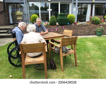 Chichester UK - July 8 2021 Selective Focused Photo Of An Outside Visit At A Care Home With Three People