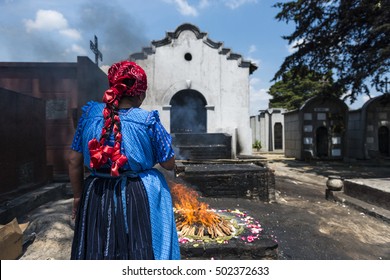 Chichicastenango, Guatemala - April 24, 2014: Maya woman performing a traditional mayan ritual in the cemetery of the town of Chichicastenango, in Guatemala