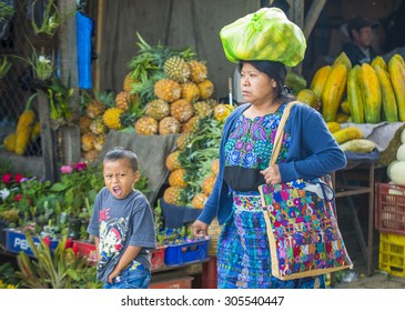 CHICHICASTENANGO , GUATEMALA - JULY 26 : Guatemalan woman buys fruits at the Chichicastenango Market on July 26 2015. This native market is the most colorful in Central America