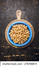 Chick Peas, Hummus In Blue Bowl With Water On Rustic Wooden Background, Top View