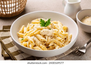 Chicken Alfredo penne, creamy pasta wich parmesan cheese in a white plate. - Powered by Shutterstock