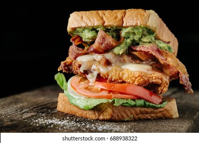 Chicken And Avocado BLT Sandwich On Black Background