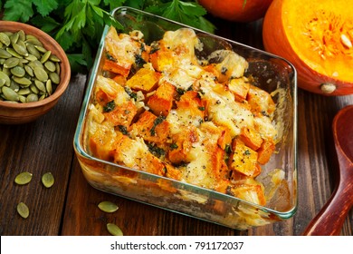 Chicken baked with pumpkin and cheese on the table - Shutterstock ID 791172037