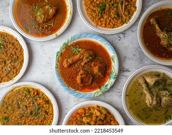 chicken or beef red karahi, daal moong, mash, chana, channay, korma, nihari, fry, makhni, qeema,white karahi served in a plate isolated on table top view of indian and assorted pakistani desi food - Shutterstock ID 2218453549